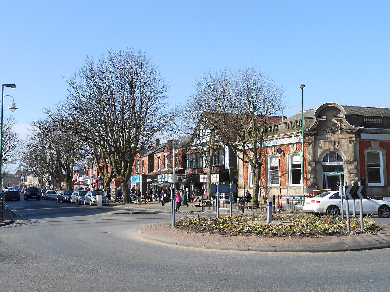 Formby village centre with shops and mature street trees