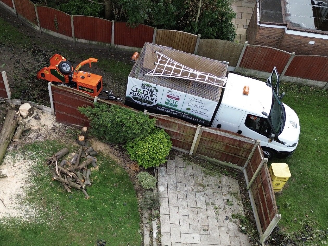 Aerial view of the James David Forestry Ltd van, chipper and truck on a residential job