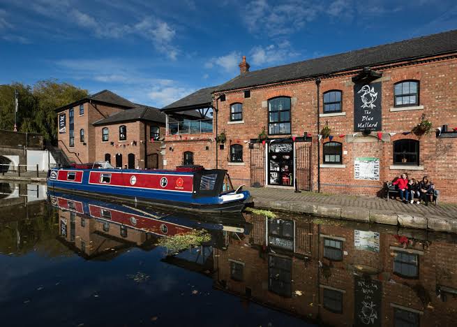 Burscough canal wharf with narrowboat and brick buildings