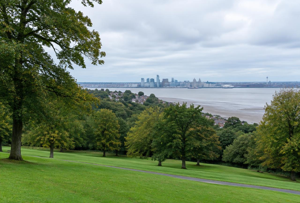 Mature parkland trees on the Wirral looking across the Mersey towards Liverpool